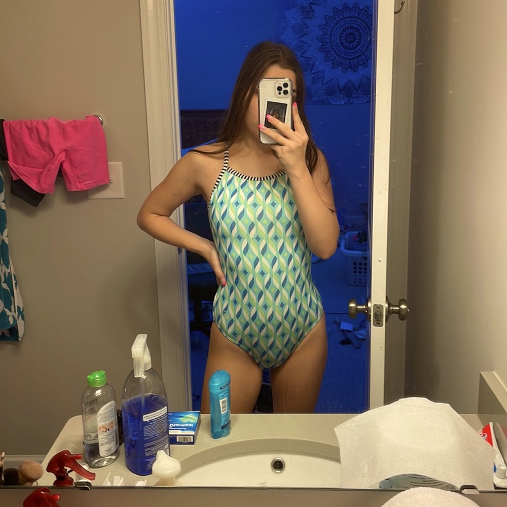 this is a very loved dolphin uglies one piece swim suit in the size 32.